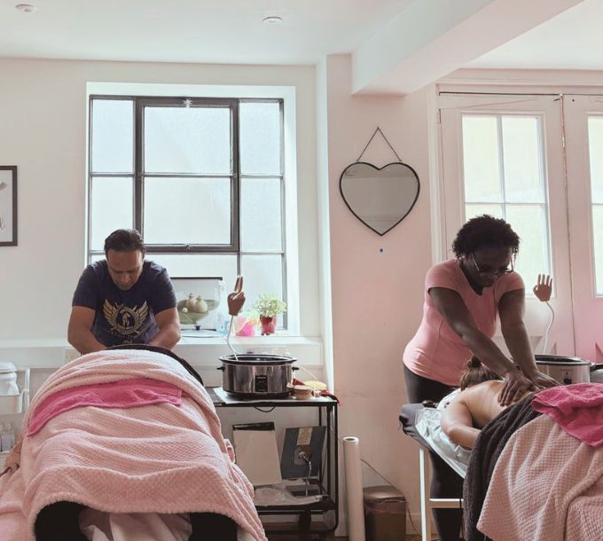 Students practising massage in a training room