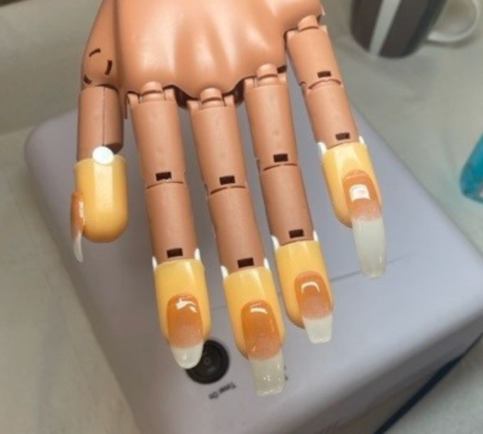 UV gel nail extensions on a practice hand