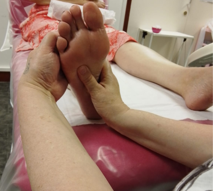 Reflexology foot treatment in a training room