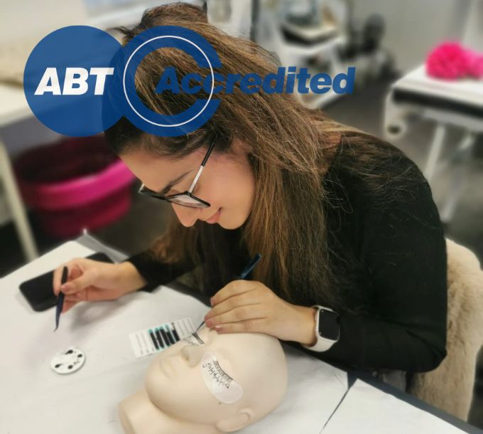 Student applying lash extensions during training