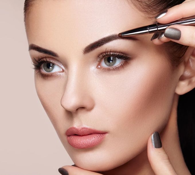 Eyebrow being shaped with tweezers