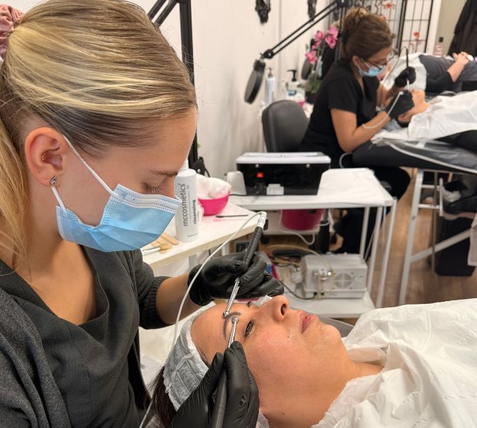 Student carrying out an electrical facial in training