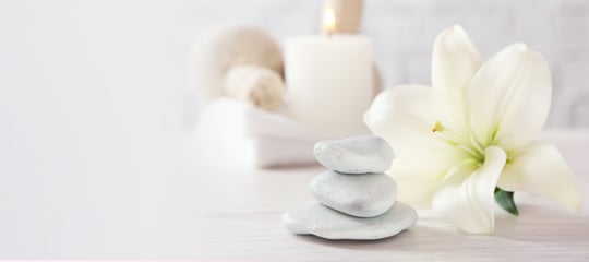 Spa stones and a white flower