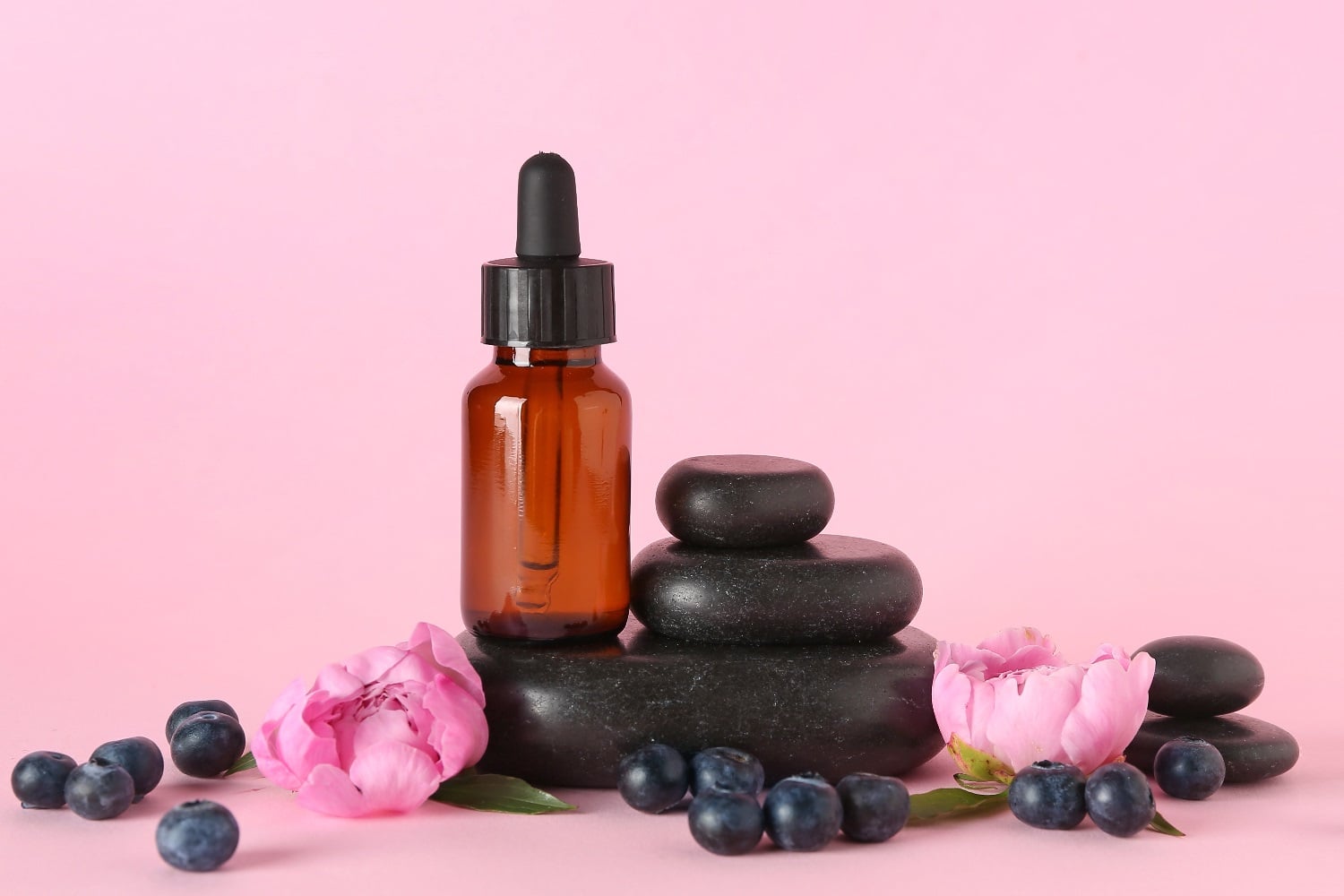 Aroma massage stones and an essential oil bottle