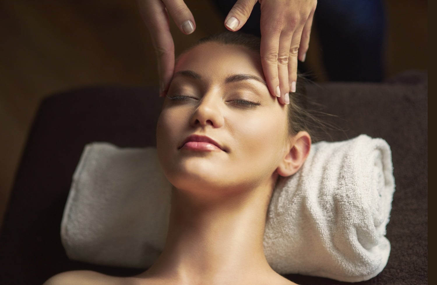 Client relaxing during a facial massage