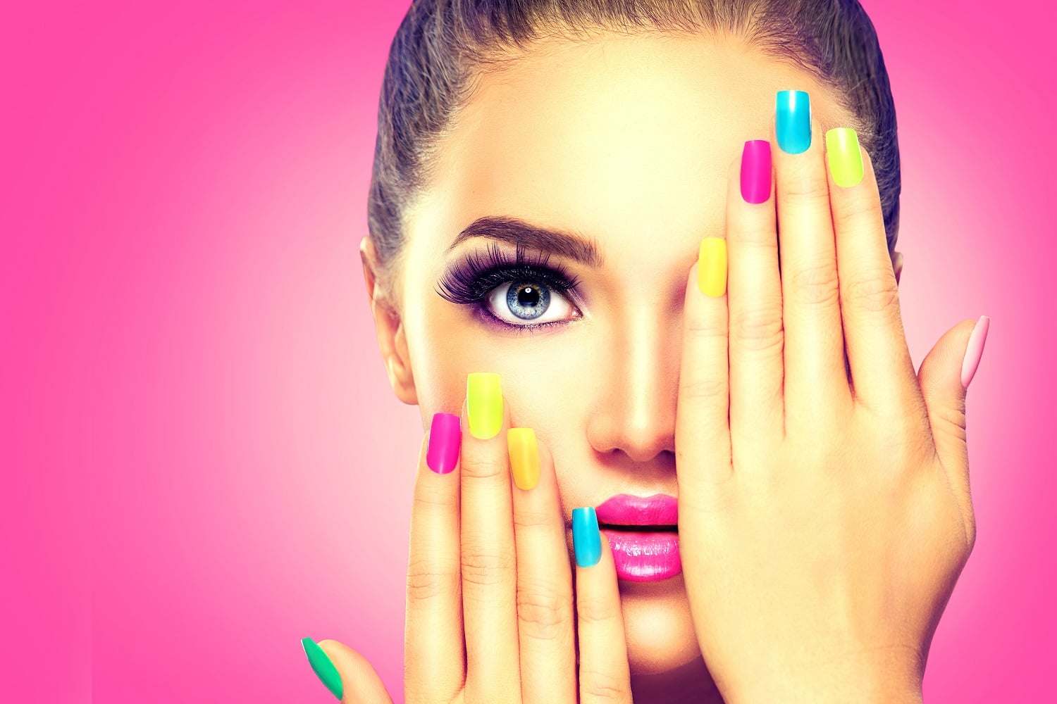 Model with colourful nails covering one eye