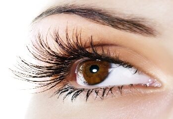 Close-up of an eye with long, full lashes