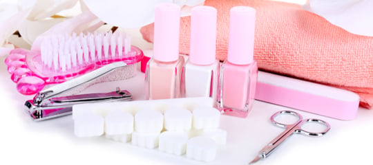 Pink manicure tools and nail polishes