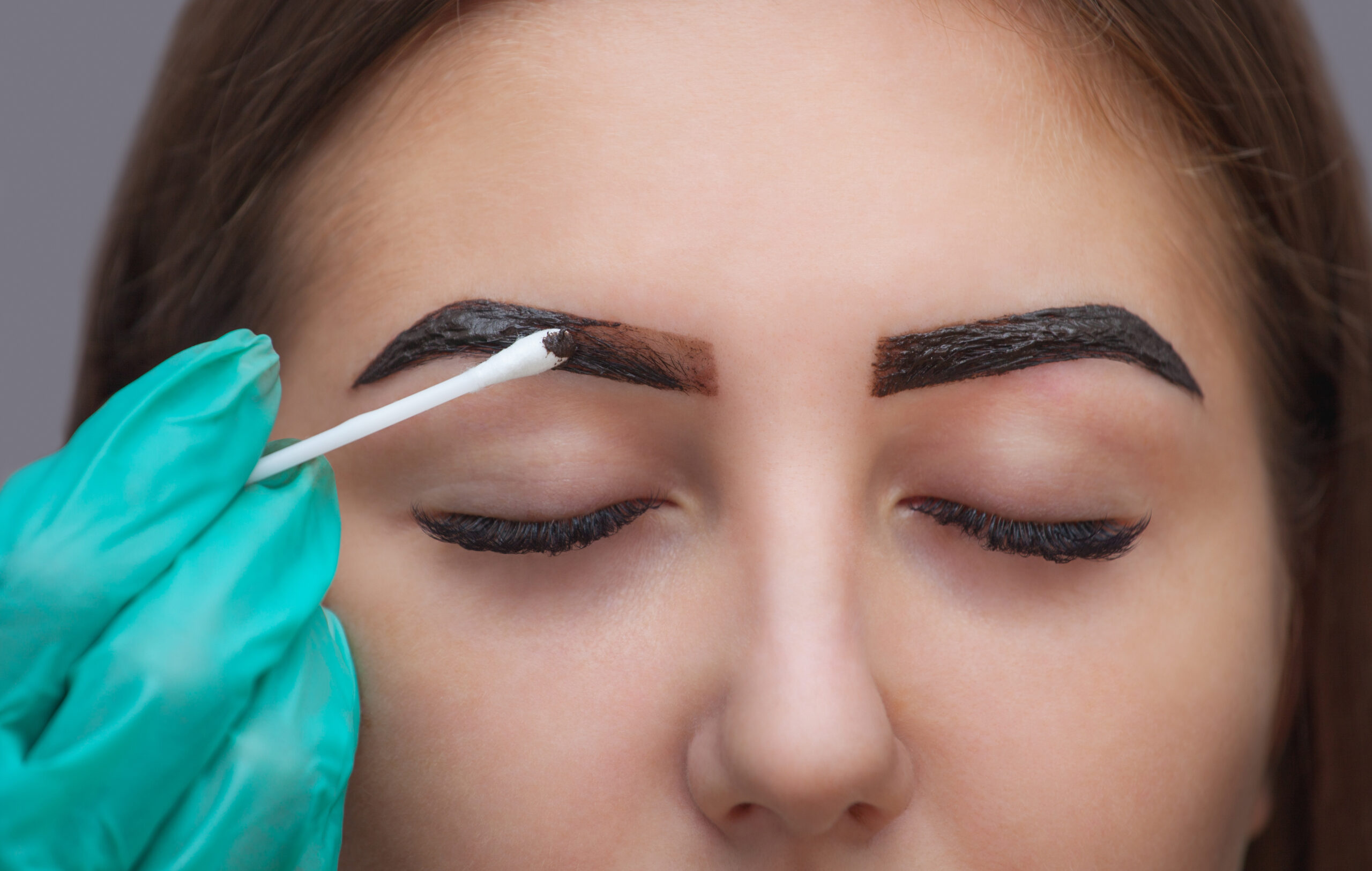 Henna brow tint being applied